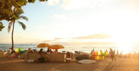 Hawaii beach with turquoise waters and palm trees.