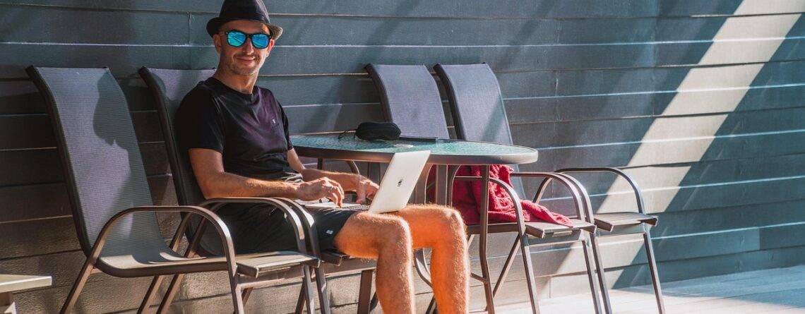 Working remotely at a beachside cafe during bleisure travel