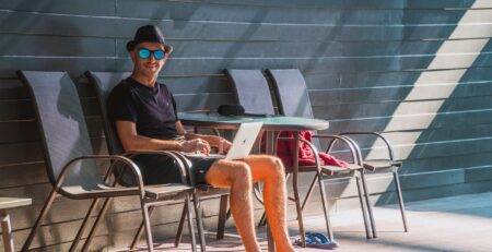 Working remotely at a beachside cafe during bleisure travel