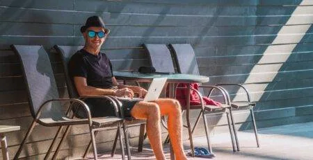 Working remotely at a beachside cafe during bleisure travel