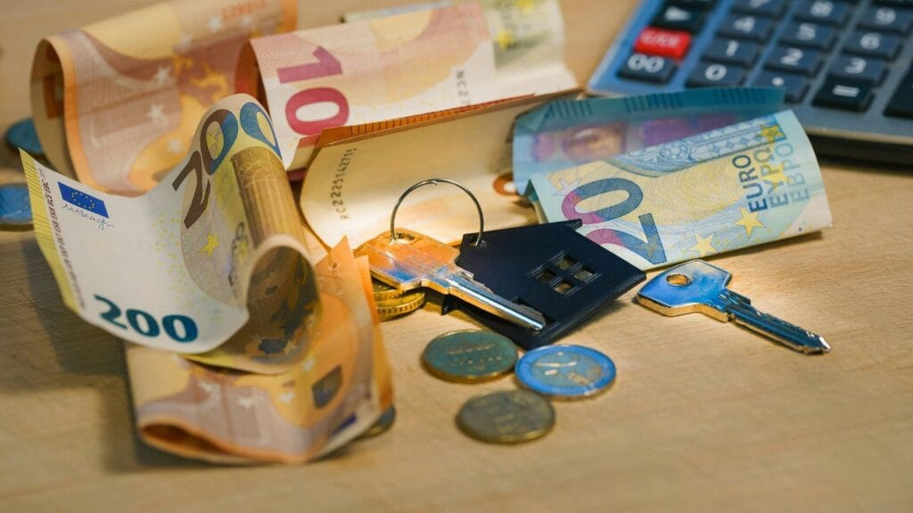 A pile of money sitting next to a calculator