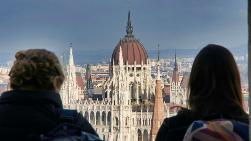 people walking on street near white and brown concrete building during daytime