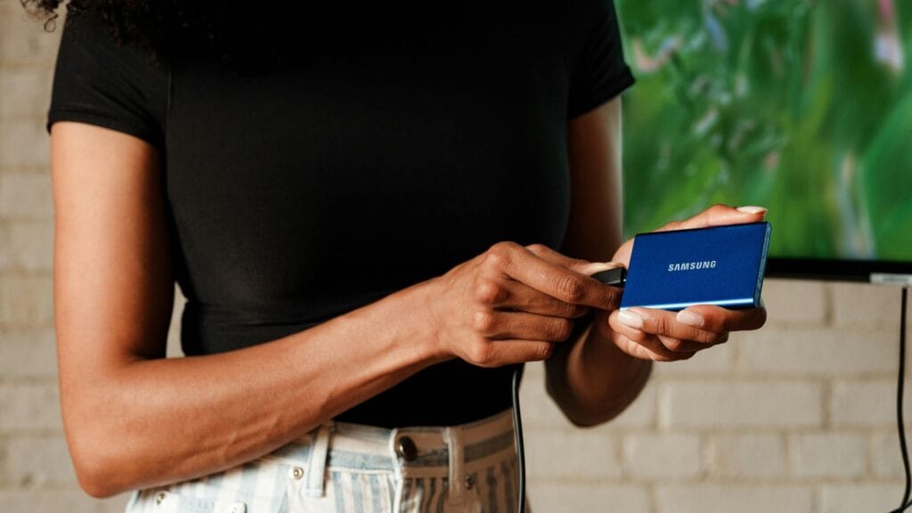 A woman standing in front of a flat screen TV