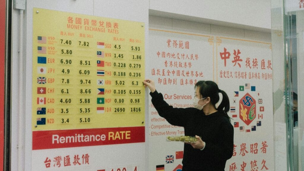 a woman standing in front of a sign pointing to a board