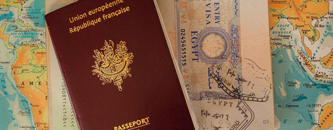 a passport sitting on top of a computer keyboard
